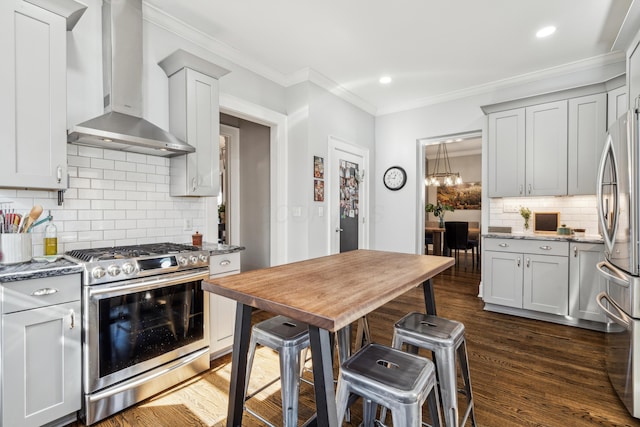 72 Miami Ave, Columbus, OH 43203 - kitchen with wall chimney exhaust hood, light stone counters, appliances with stainless steel finishes, and dark wood-type flooring