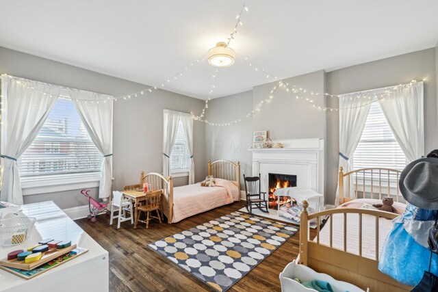 72 Miami Ave, Columbus, OH 43203 - bedroom featuring baseboards, a lit fireplace, and wood finished floors