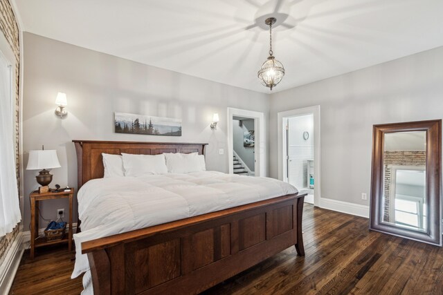 72 Miami Ave, Columbus, OH 43203 - bedroom with dark wood-style floors, ensuite bath, and baseboards
