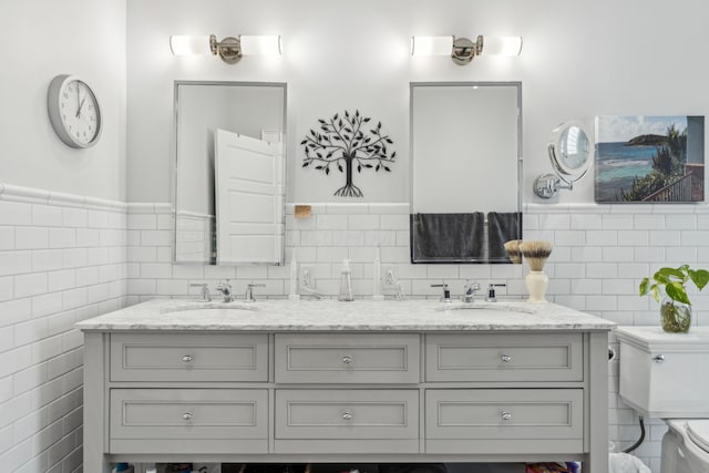 72 Miami Ave, Columbus, OH 43203 - full bathroom with toilet, a sink, double vanity, and tile walls