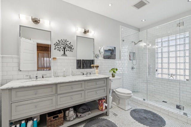 72 Miami Ave, Columbus, OH 43203 - full bath featuring tile walls, visible vents, a shower stall, a sink, and tile patterned flooring