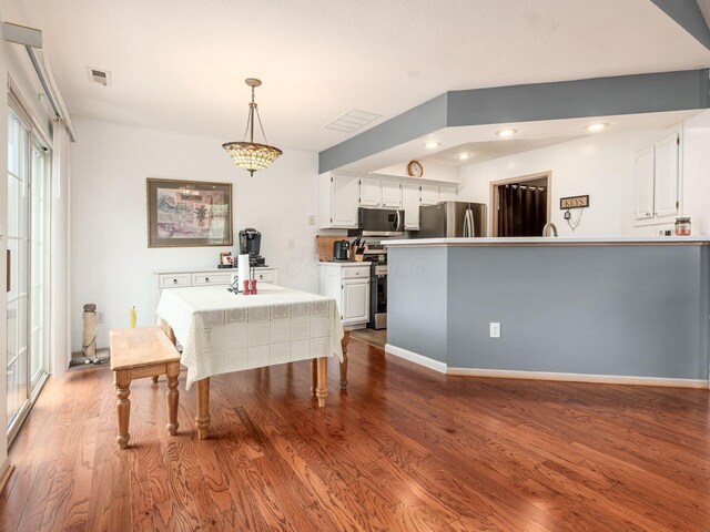 dining room featuring visible vents, recessed lighting, and wood finished floors