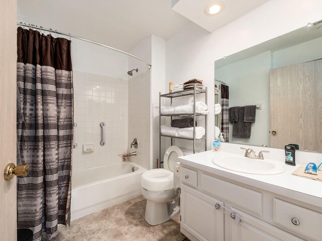full bath featuring vanity, shower / bath combo with shower curtain, and toilet