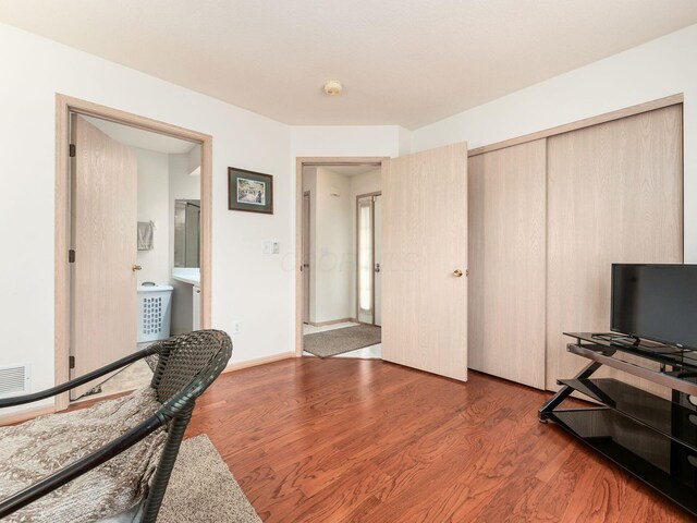 office space with wood finished floors and visible vents