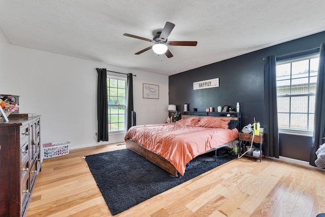 51 Township Rd Unit 1357, South Point, OH 45680 - bedroom featuring wood finished floors, a textured ceiling, ceiling fan, and baseboards