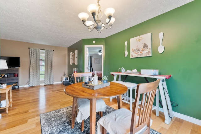 51 Township Rd Unit 1357, South Point, OH 45680 - dining area featuring a chandelier, a textured ceiling, wood finished floors, and baseboards