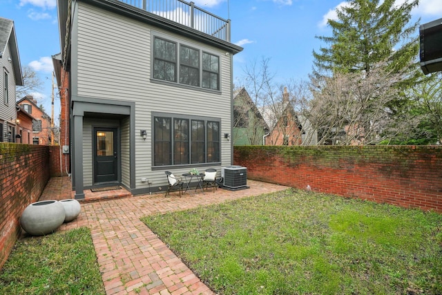 324 Jackson St, Columbus, OH 43206 - rear view of property featuring a fenced backyard, a lawn, a patio area, and central AC unit