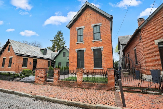 324 Jackson St, Columbus, OH 43206 - traditional-style home with a fenced front yard, a gate, and brick siding