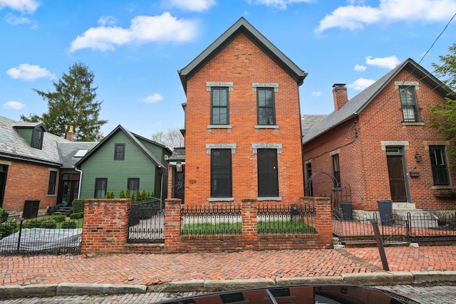 324 Jackson St, Columbus, OH 43206 - traditional-style house with a fenced front yard and brick siding