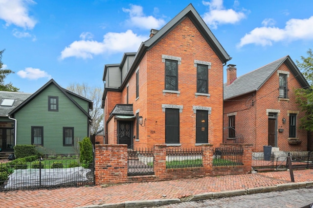 324 Jackson St, Columbus, OH 43206 - view of front facade featuring brick siding and a fenced front yard