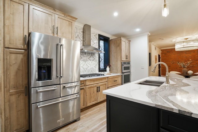 324 Jackson St, Columbus, OH 43206 - kitchen featuring crown molding, backsplash, a sink, appliances with stainless steel finishes, and wall chimney exhaust hood