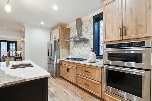 324 Jackson St, Columbus, OH 43206 - kitchen featuring crown molding, a sink, wall chimney exhaust hood, light wood-type flooring, and stainless steel appliances
