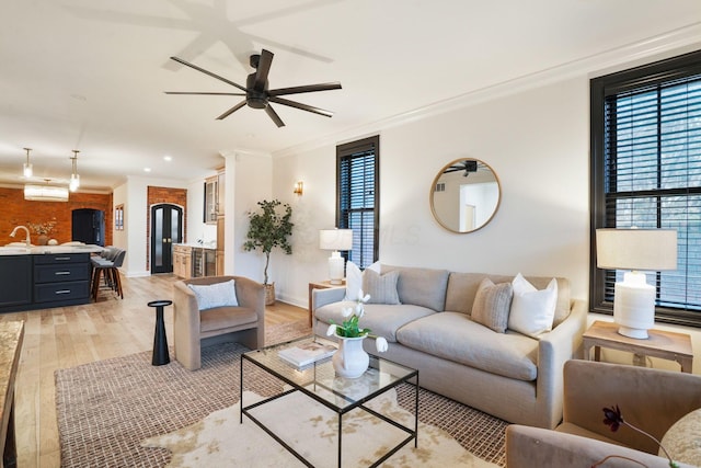 324 Jackson St, Columbus, OH 43206 - living area featuring baseboards, ornamental molding, light wood-style floors, and ceiling fan