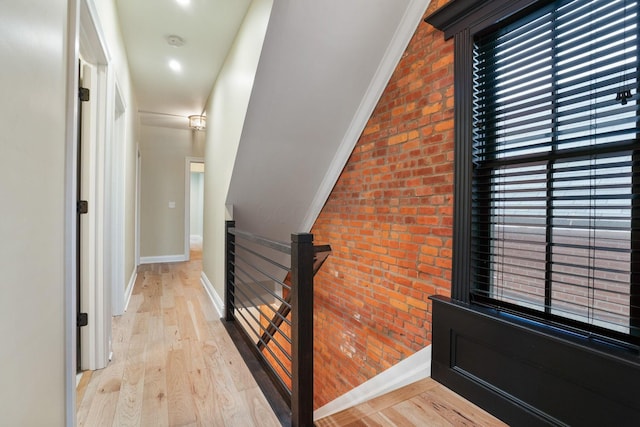 324 Jackson St, Columbus, OH 43206 - corridor featuring baseboards, an upstairs landing, brick wall, and light wood finished floors