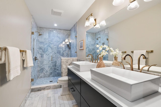 324 Jackson St, Columbus, OH 43206 - bathroom with wood tiled floor, toilet, a sink, and a marble finish shower