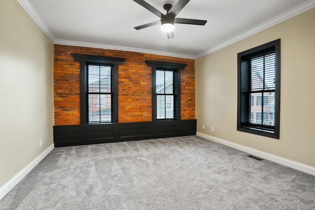 324 Jackson St, Columbus, OH 43206 - spare room with crown molding, carpet flooring, brick wall, visible vents, and a ceiling fan