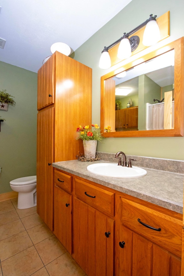 bathroom featuring toilet, vanity, tile patterned flooring, and visible vents