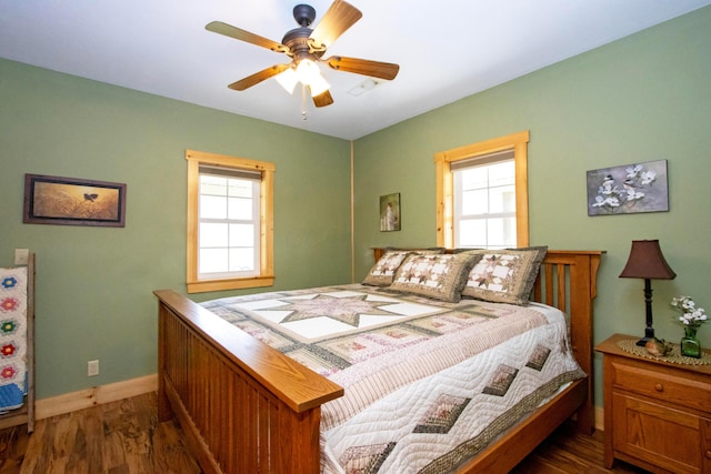 bedroom featuring dark wood-type flooring, ceiling fan, and baseboards