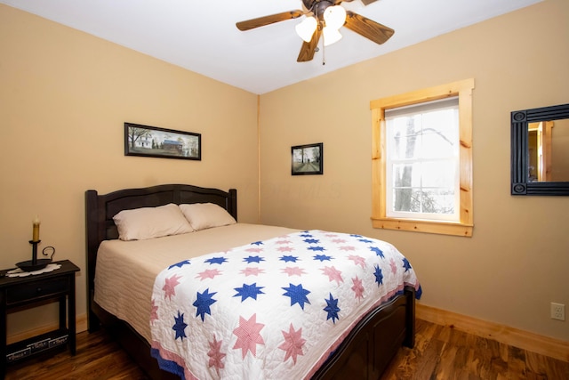bedroom with baseboards, wood finished floors, and ceiling fan
