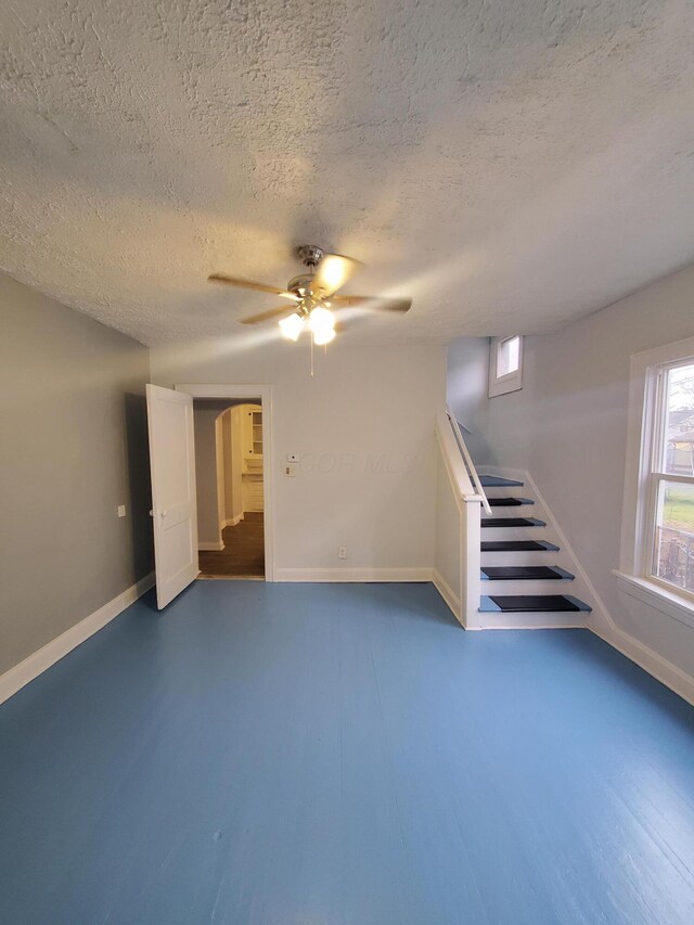 1273-1275 E 18th Ave, Columbus, OH 43211 - unfurnished living room with ceiling fan, baseboards, wood finished floors, and a textured ceiling