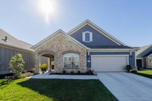 5165 Bluffton Way, Delaware, OH 43015 - craftsman-style house with a garage, stone siding, a front yard, and concrete driveway
