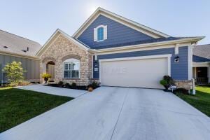 5165 Bluffton Way, Delaware, OH 43015 - craftsman inspired home featuring a garage, a front lawn, driveway, and stone siding