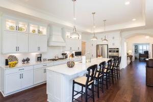5165 Bluffton Way, Delaware, OH 43015 - kitchen with a center island with sink, light countertops, a breakfast bar, stainless steel appliances, and extractor fan