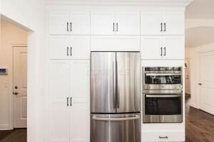 5165 Bluffton Way, Delaware, OH 43015 - kitchen with dark wood-style flooring, stainless steel appliances, and white cabinetry