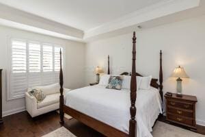 5165 Bluffton Way, Delaware, OH 43015 - bedroom featuring baseboards, wood finished floors, and a tray ceiling
