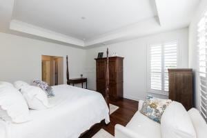 5165 Bluffton Way, Delaware, OH 43015 - bedroom featuring a raised ceiling and dark wood-style flooring