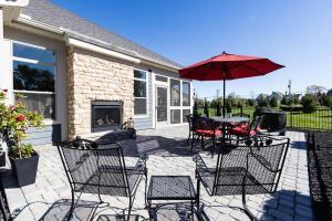 5165 Bluffton Way, Delaware, OH 43015 - view of patio featuring exterior fireplace, fence, and outdoor dining space