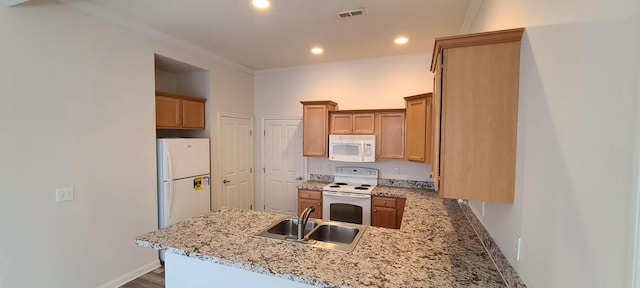 kitchen with visible vents, a sink, white appliances, crown molding, and a peninsula