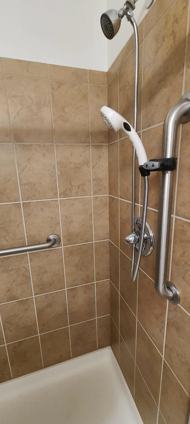 bathroom with a tile shower
