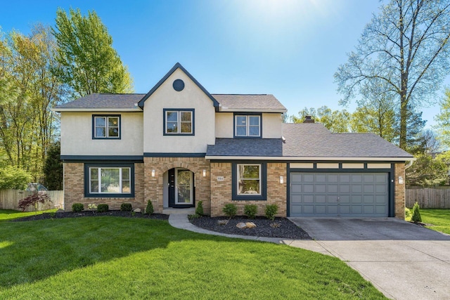 traditional home featuring fence, brick siding, a garage, stucco siding, and driveway