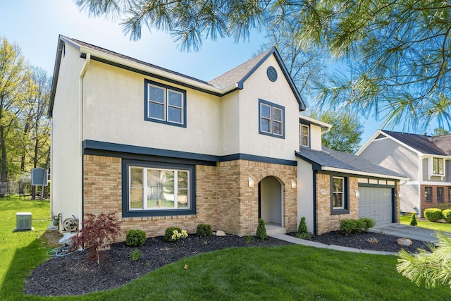 traditional-style house with a garage, stucco siding, and a front lawn