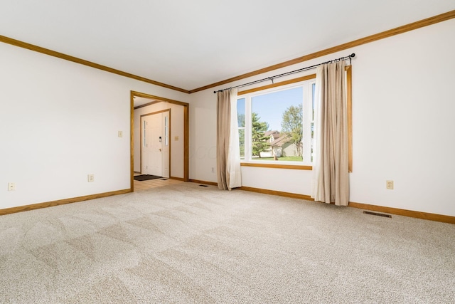 unfurnished room with baseboards, ornamental molding, carpet flooring, and visible vents