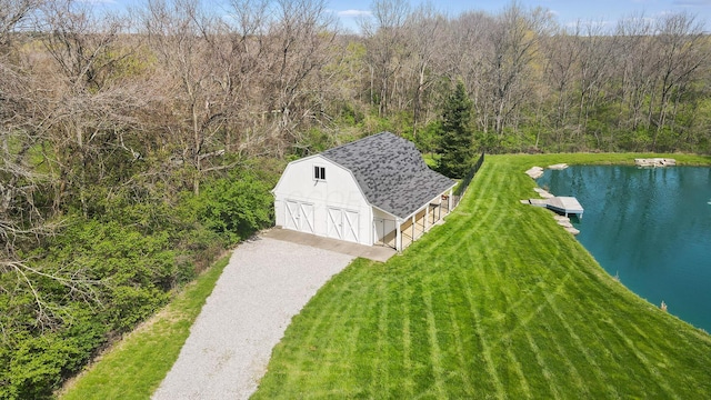 birds eye view of property with a view of trees and a water view