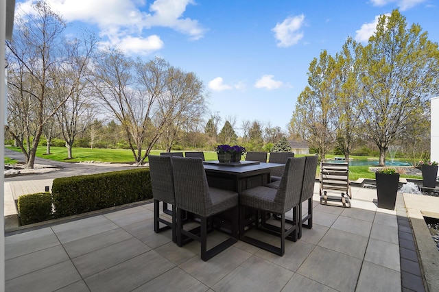 view of patio / terrace with outdoor dining area and a water view