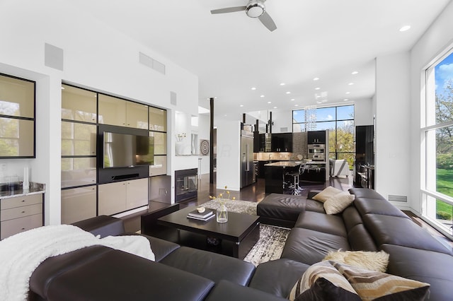 living area with visible vents, recessed lighting, ceiling fan, and a healthy amount of sunlight