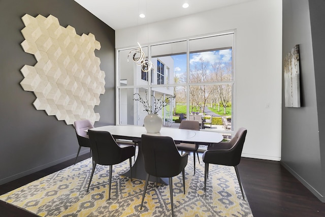 dining space with wood finished floors, baseboards, and recessed lighting