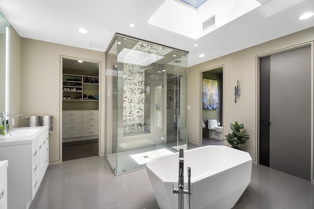 bathroom with a shower stall, a soaking tub, and recessed lighting