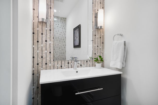bathroom featuring tasteful backsplash and vanity