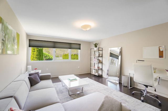 living room featuring baseboards and dark wood finished floors