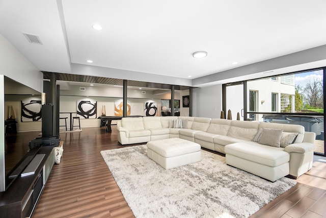 living room featuring wood finished floors, visible vents, and recessed lighting