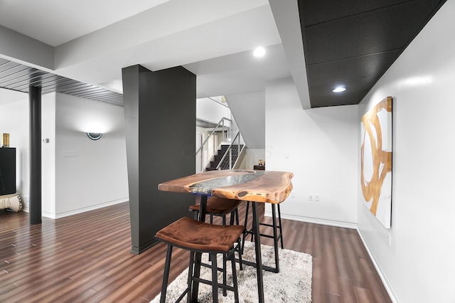 dining space featuring recessed lighting, wood finished floors, baseboards, and stairway