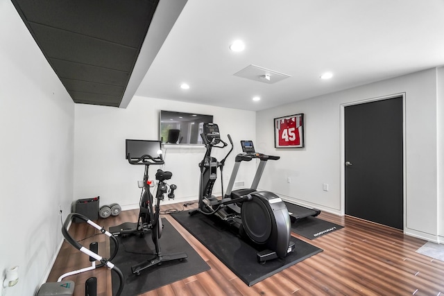exercise area with recessed lighting, wood finished floors, and baseboards