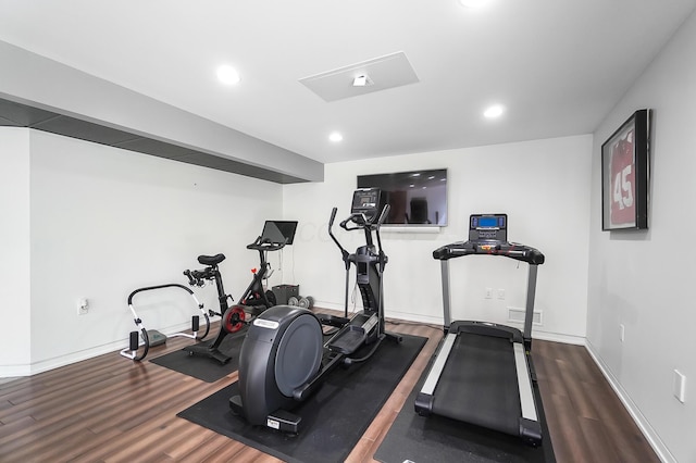 workout area featuring baseboards, wood finished floors, and recessed lighting