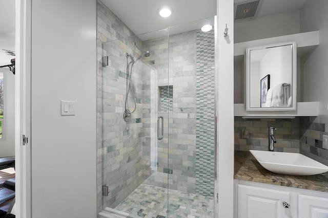 full bathroom with recessed lighting, tasteful backsplash, a shower stall, and visible vents