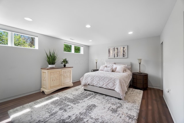 bedroom featuring baseboards, dark wood-type flooring, and recessed lighting