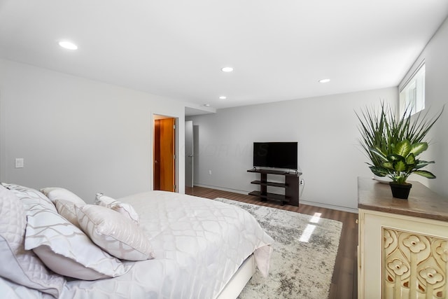 bedroom featuring wood finished floors and recessed lighting